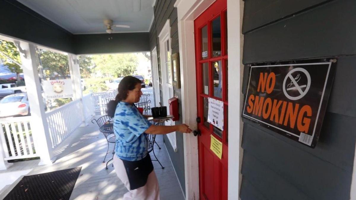 Waitress Tina Heathroe walks into Buzzy's Breakfast Joint in Ocean Springs after clearing a table on Thursday, Oct. 13, 2016. Buzzy's, like many Ocean Springs restaurants and bars, already prohibits smoking inside.