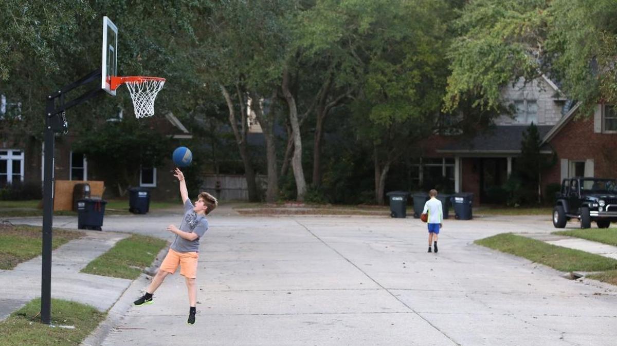 Evan Boudreaux, 12, plays basketball Monday, Nov. 6, 2017 on a goal that has put he and his father, Dale, in a legal battle with their neighbors in the Bienville Place development in Ocean Springs.