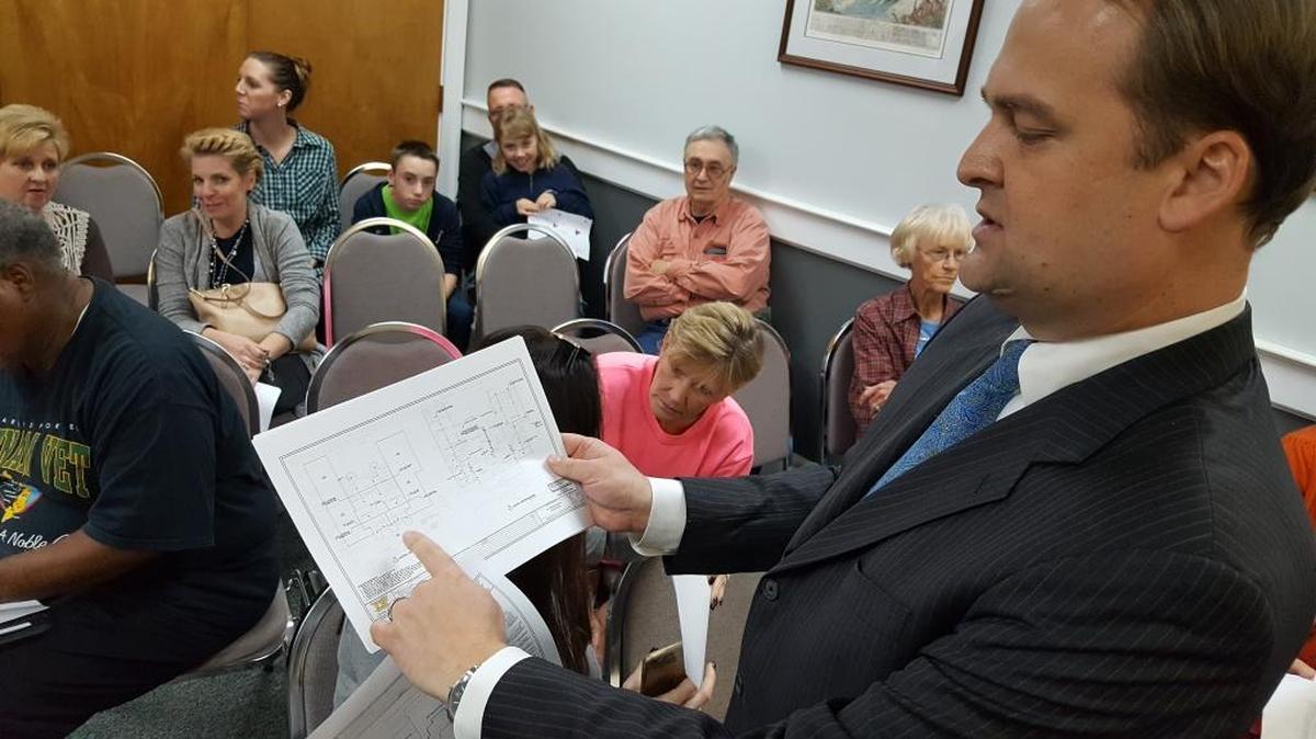 Scott Walker, at an aldermen meeting earlier this year, shows plans for a sprinkler system in his East Beach home that he hopes will help him secure a permit to run a bed and breakfast in his Ocean Springs home.