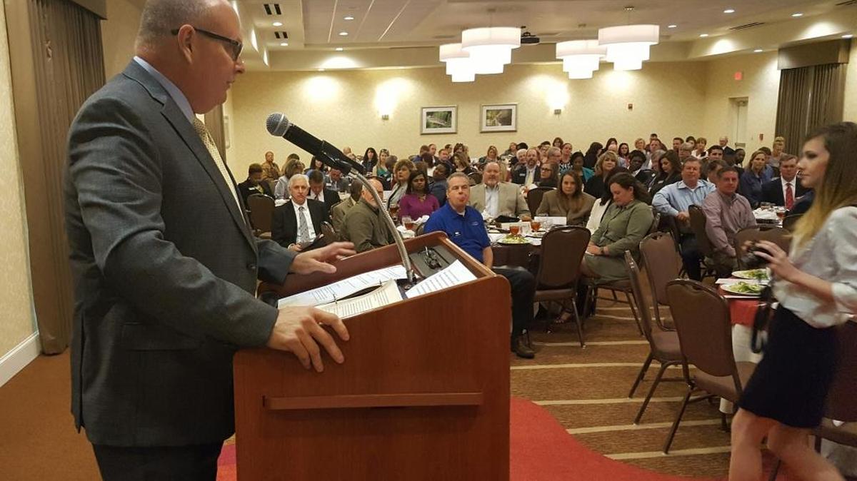 Outgoing Jackson County Chamber of Commerce Chair Brad Bradford addresses a packed house Tuesday.
