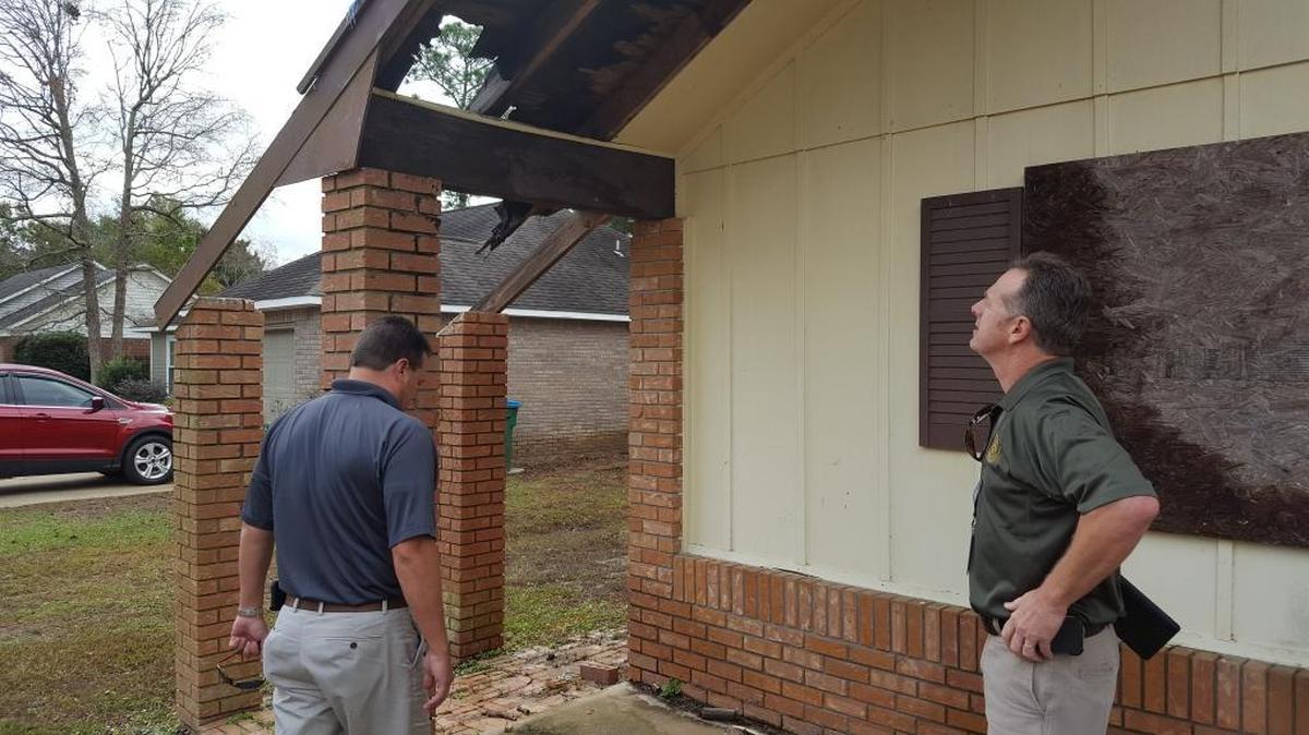 Jackson County’s code enforcement officer, Jeff Barlow, right, is compiling a list of blighted properties, like this one in the Pinehurst subdivision of south Jackson County, so the county can utilize U.S. Treasury money to have them demolished.