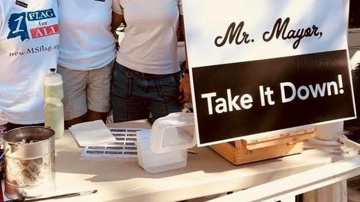 The Mississippi Rising Coalition had a booth at Peter Anderson Festival in downtown Ocean Springs asking Mayor Shea Dobson take down the state flag flying at City Hall.
