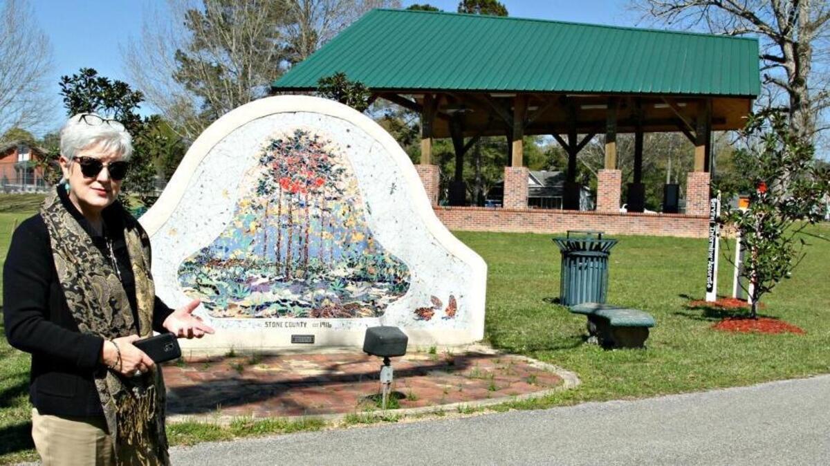 Betsy Rowell, executive director of the Stone County Economic Development Partnership, talks about the six tile murals in Blaylock Park by Coast artist Elizabeth Veglia, with assistance from the students of Sandra Cassibry of MGCCC’s Perkinston campus. This mural is called ‘Longleaf Pine.’