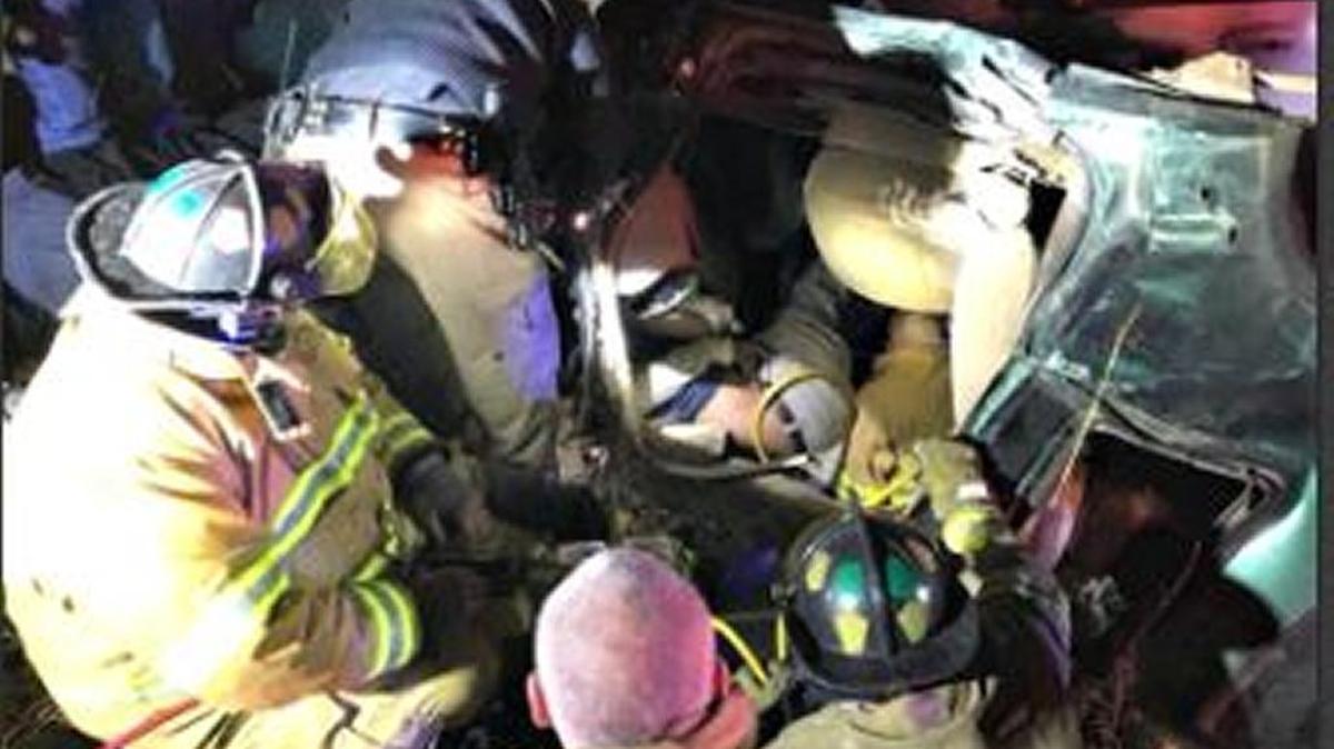 Wiggins firefighters use an air bag to free a man's arm after it was trapped under his overturned vehicle as sleet fell Tuesday night in Stone County.