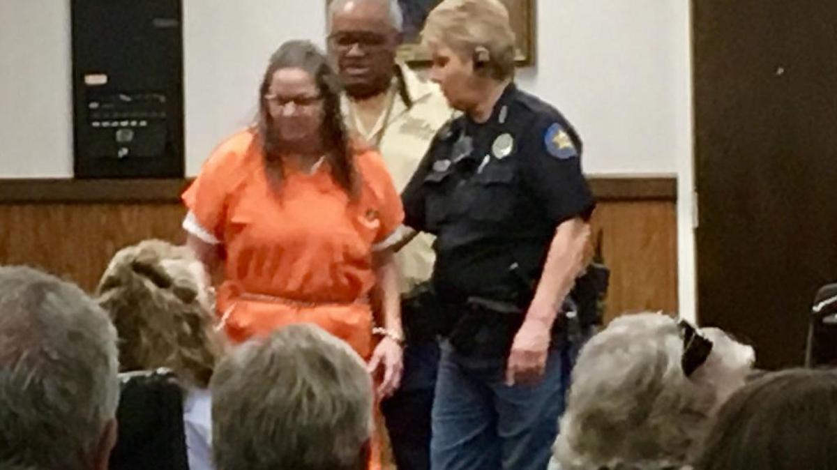 Evelyn Garrison is led into court in Harrison County on Monday. She pleaded guilty to first degree murder in the 2015 death of her husband, Timothy 'Timmy' Garrison.
