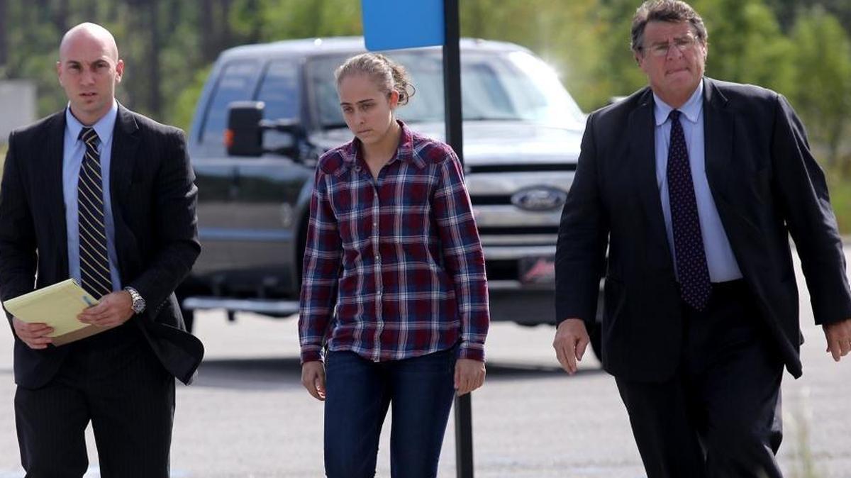 Former Long Beach Police Officer Cassie Barker walks into the Hancock County Public Safety Complex with lawyers George Blair, left, and Donald Rafferty on Thursday, October 6, 2016. A warrant was issued for her arrest on a charge of manslaughter involved in the death of her daughter, Cheyenne Hyer, 3. A grand jury upgraded the charge to second degree murder.