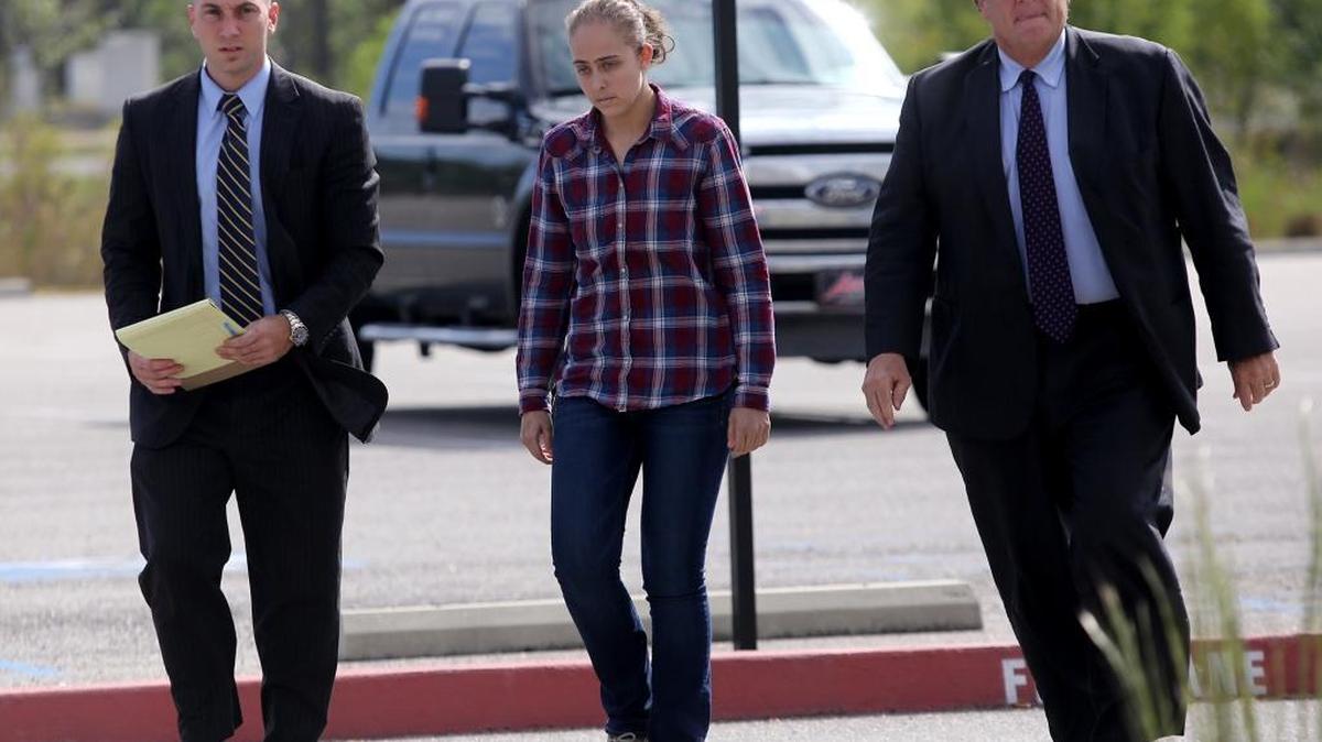 Former Long Beach police officer Cassie Barker walks into the Hancock County Public Safety Complex with lawyers George Blair, left, and Donald Rafferty on Thursday, Oct. 6, 2016. A warrant was issued for her arrest on a charge of manslaughter involved in the death of her daughter, Cheyenne Hyer, 3.