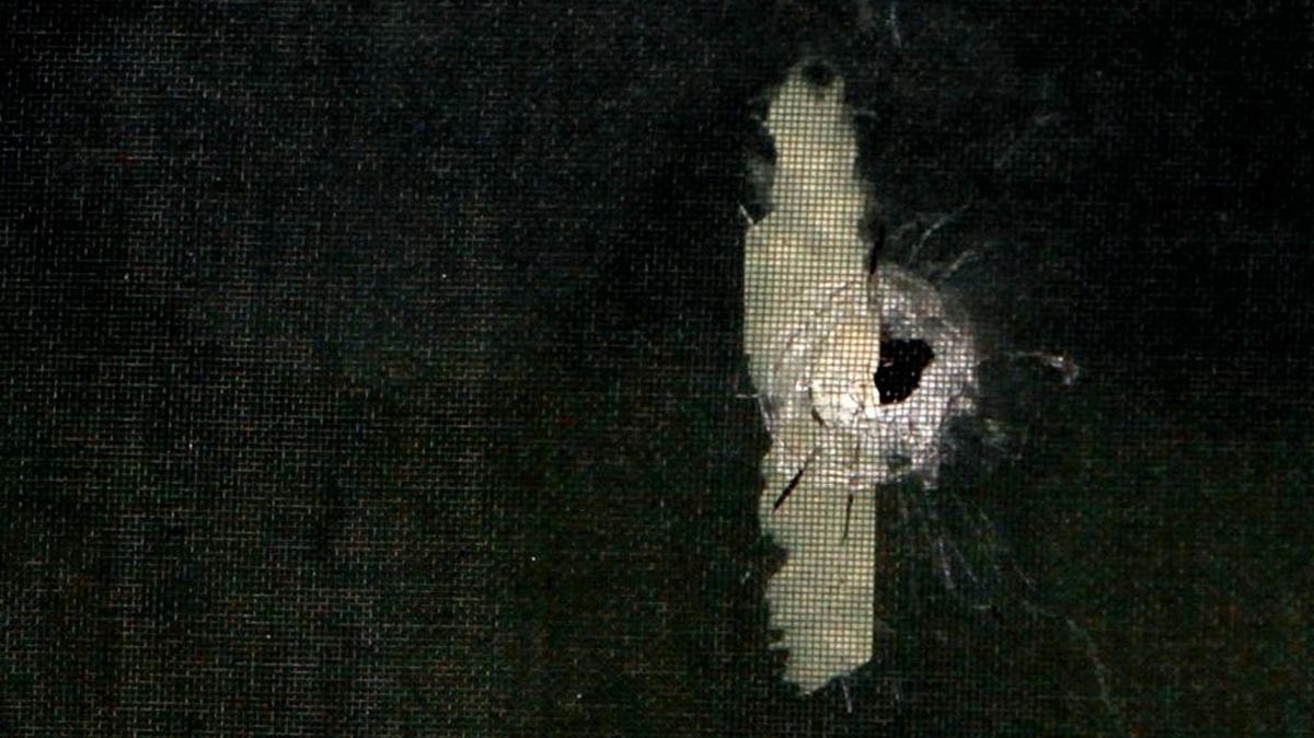 A bullet hole can be seen in the front window of the home of a double homicide that happened July 30, 2016, at Bay Pines in Bay St. Louis.
