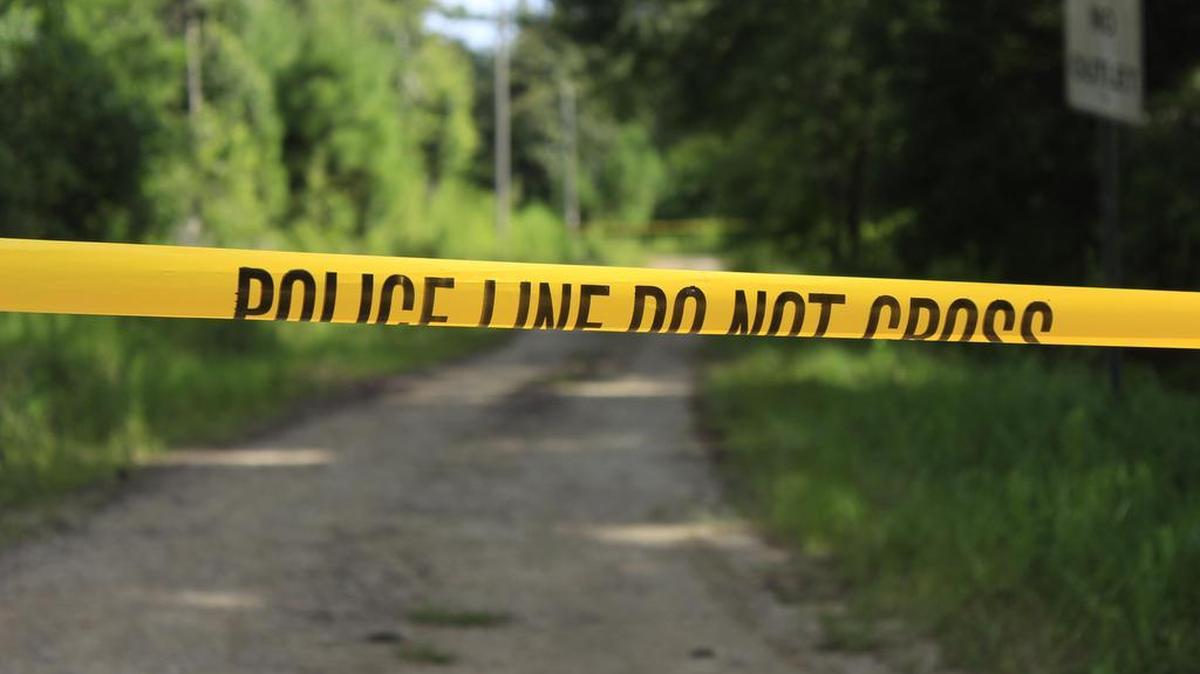 Crime scene tape on Chesapeake Street marks the area where Waveland police recovered a man's body on Monday, July 11, 2016.