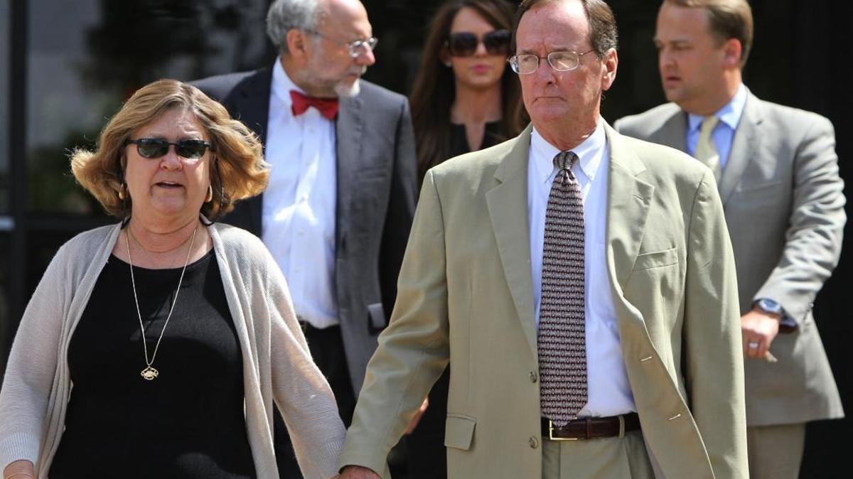 Former Mississippi Department of Marine Resources Director Bill Walker and his wife, Sharon, leave the federal courthouse in Hattiesburg on June 16, 2014, after Bill was sentenced for five years in prison on charges of conspiring to defraud the government. At right is Walker’s son, Scott.