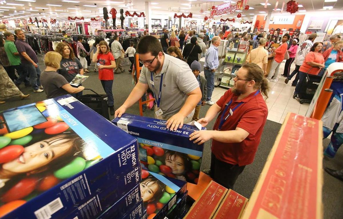 Kohl’s employees hand down televisions to shoppers during Black Friday in 2015 at The Promenade in D’Iberville. The Black Friday rush is a little less hectic 10 years later as many retailers let shoppers order the big deals online and pick up at the stores.