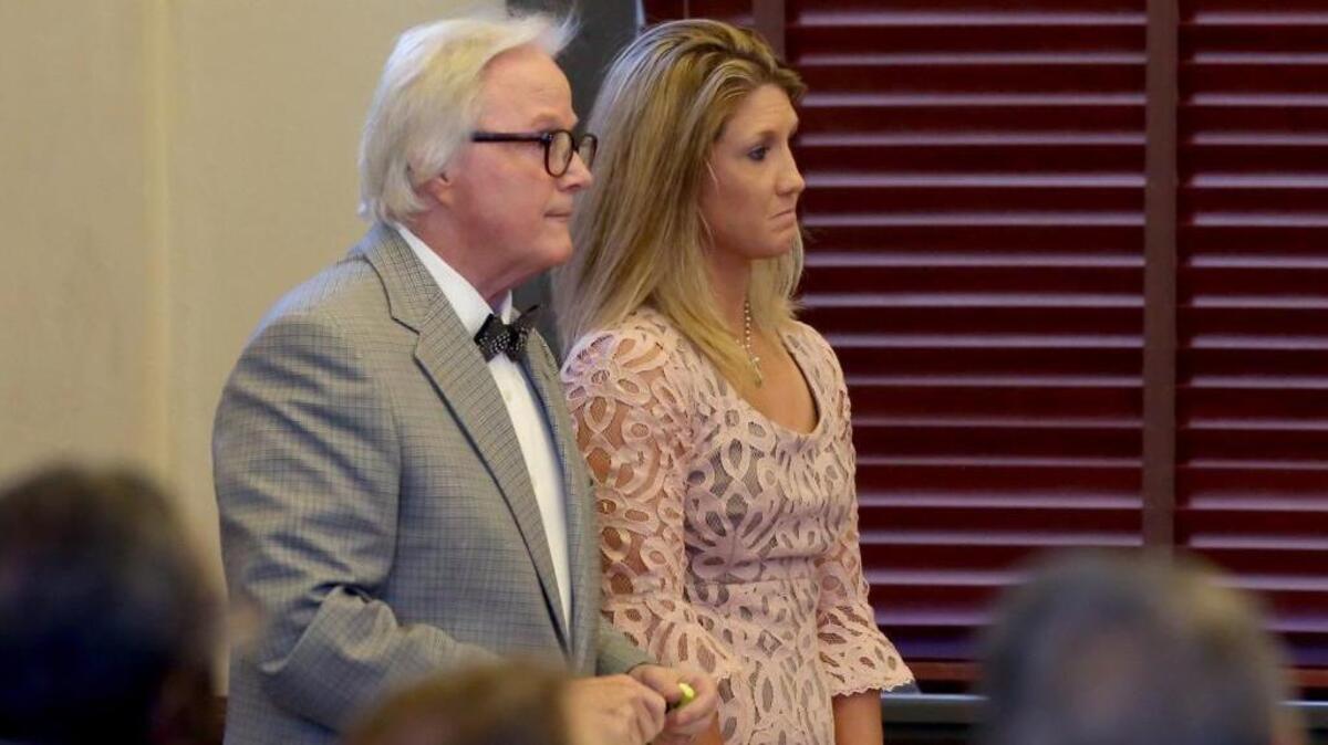 Attorney Jim Davis and client Leslie DeWitt receive a jury’s verdict in Hancock County Circuit Court, where she was found guilty of twice touching a 16-year-old student for lustful purposes. DeWitt, sentenced to 30 years in prison, plans to appeal to the state Supreme Court for a new trial.