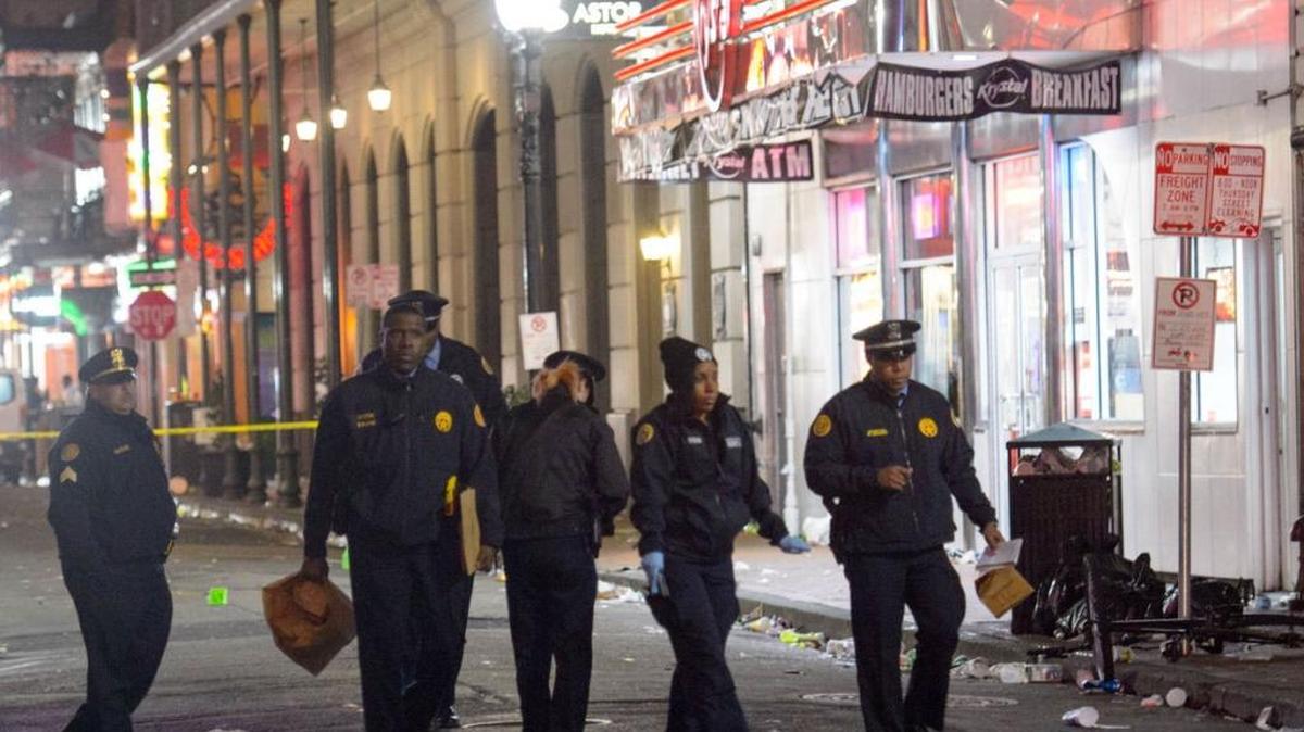New Orleans Police Department investigators study a crime scene near Bourbon and Canal streets after 10 people were shot and one killed in New Orleans on Sunday, November 27, 2016.