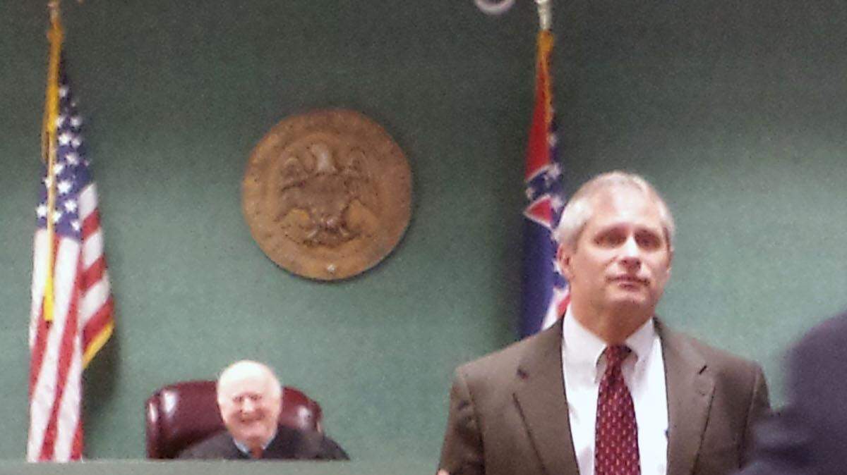 District attorney Tony Lawrence talks with  Jimmy Heidelberg and his client, Tommy Robertson, before Robertson's hearing Monday. The former state senator pleaded guilty to embezzlement.