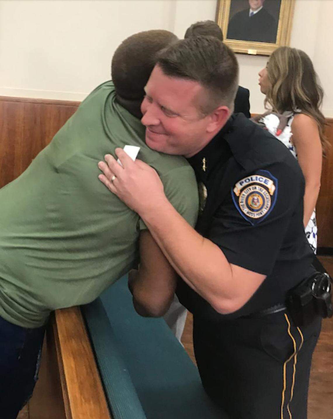 Leontyne Daily, sister of the shooting victim Fabian Dailey, hugs Moss Point Police Chief Brandon Ashley after a press conference announcing four arrests in the killing on Wednesday, Aug. 22, 2018.