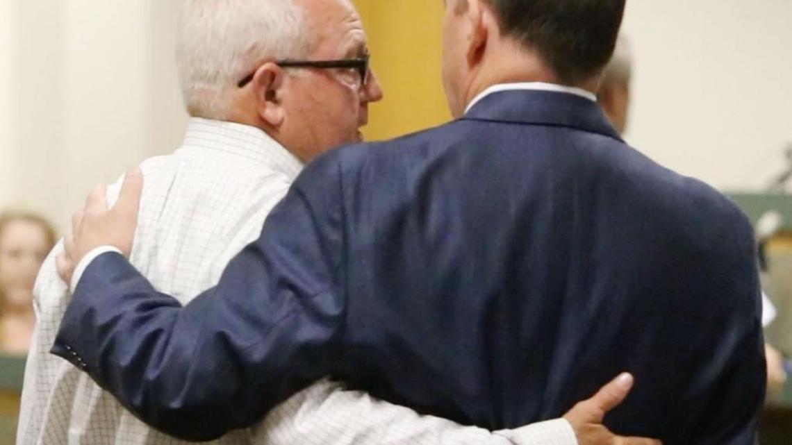 Former State Sen. Tommy Robertson, left, embraces his attorney, James Heidelberg, after being sentenced to 10 years with two years to serve in prison in Jackson County Circuit Court on embezzlement charges on Monday.