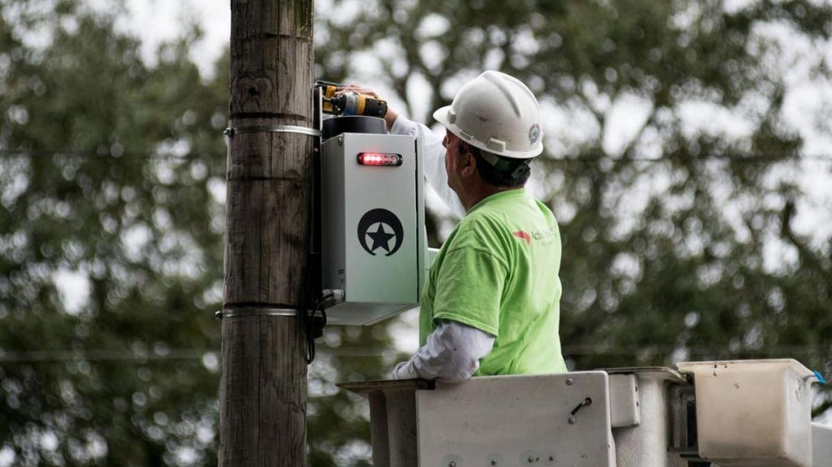 Contractors work on a NOPD security camera at the corner of Foucher and St. Charles Avenue.