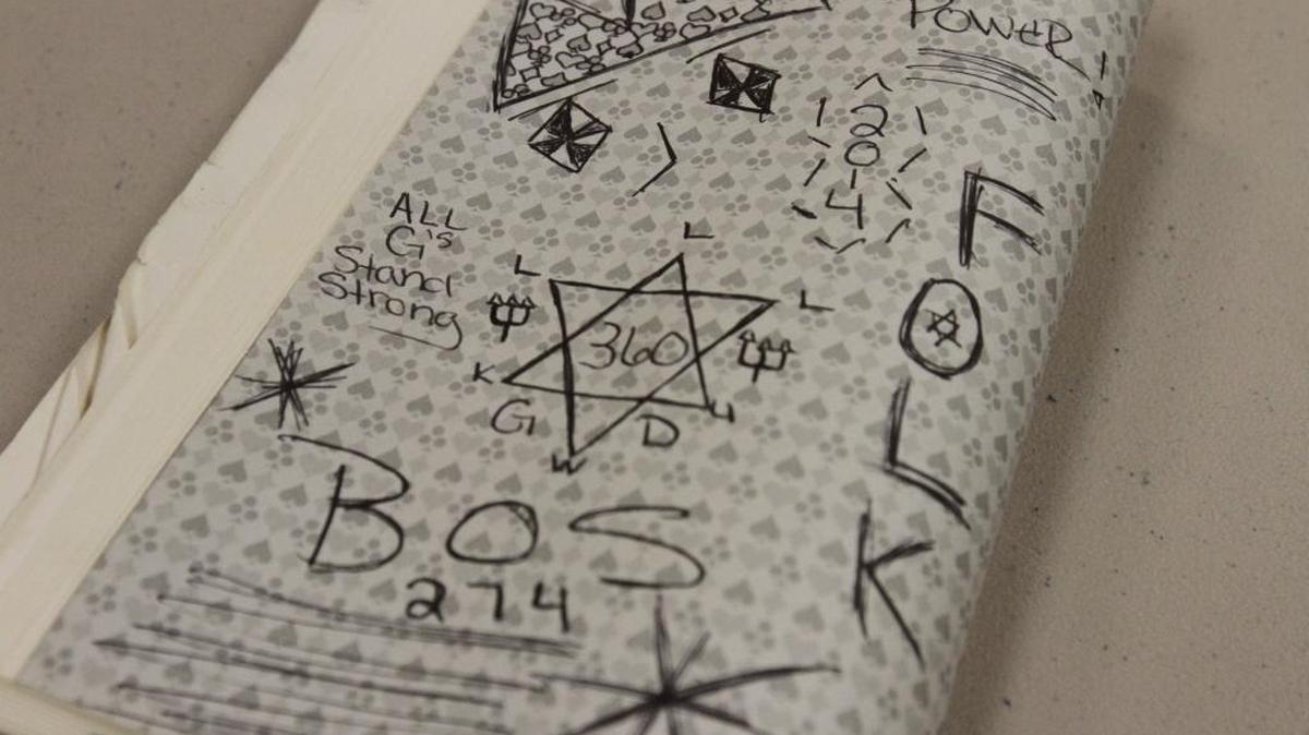 Gang-related graffiti in a book confiscated at the George/Green County Regional Correctional Facility in Lucedale, where officials say a significant portion of the inmates are gang members.