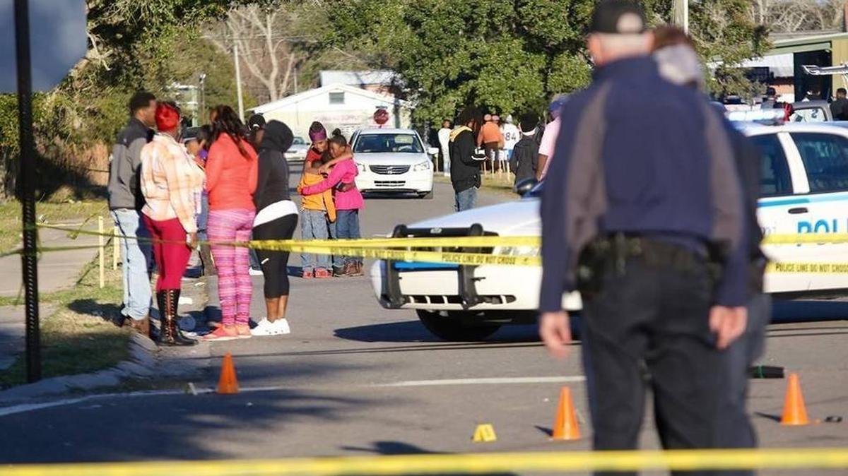 Family members of shooting victims comfort each other in Pass Christian after shootings occurred following the St. Paul Carnival Association Mardi Gras parade on Feb. 7, 2016. Two people died in the gunfire.