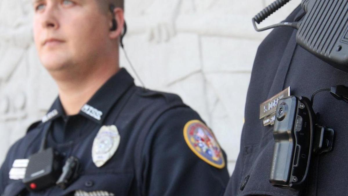 Biloxi police patrolmen Steven Dorcik, right, and Aaron Allen show the body cameras their officers were wearing in 2015. The system was not specifically designed for police work, but was used until the department bought a better system in 2016.