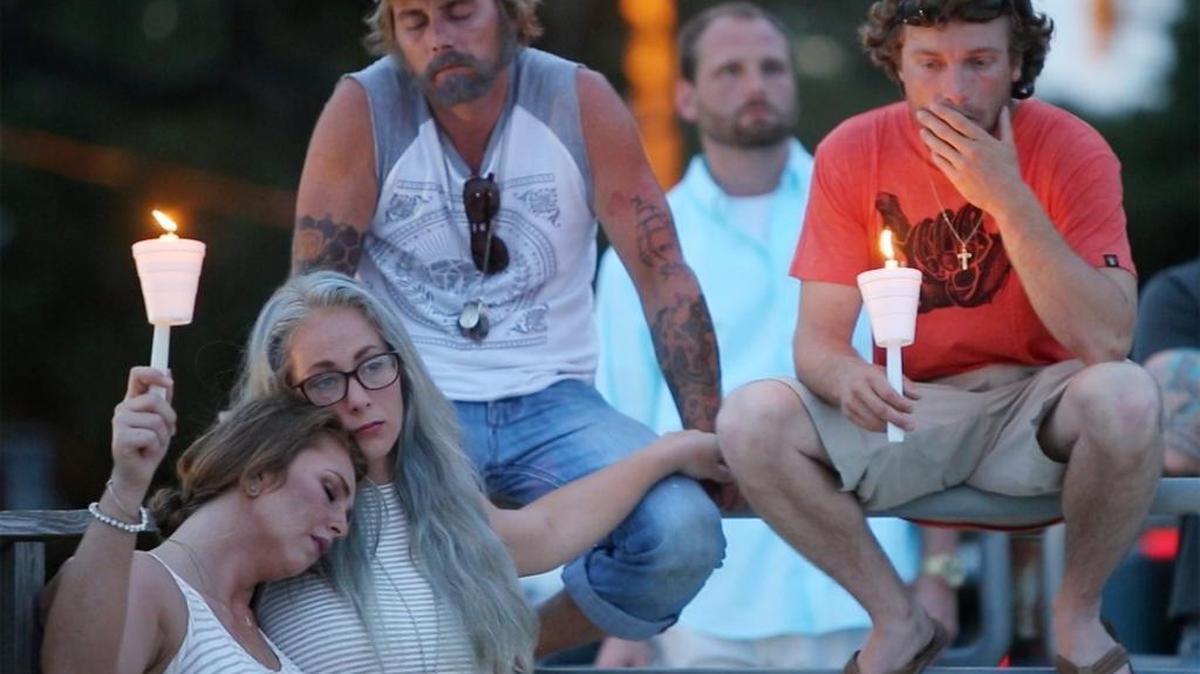 Jessie Bardwell's brother, Brandon, center, and his wife, Kayla sit with Sara Houston, left, and Paul Schrage during a ceremony to pray for Jessie Bardwell on the beach in Pascagoula on Sunday May 15, 2016. She was found dead in a field in Texas, where she had moved with her new boyfriend.