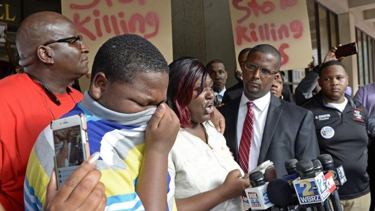 Cameron Sterling, 15, cries as his mother Quinyetta McMillon speaks to the shooting as family and political leaders gather for a press conference and protest at city hall Wednesday morning July 6, 2016.