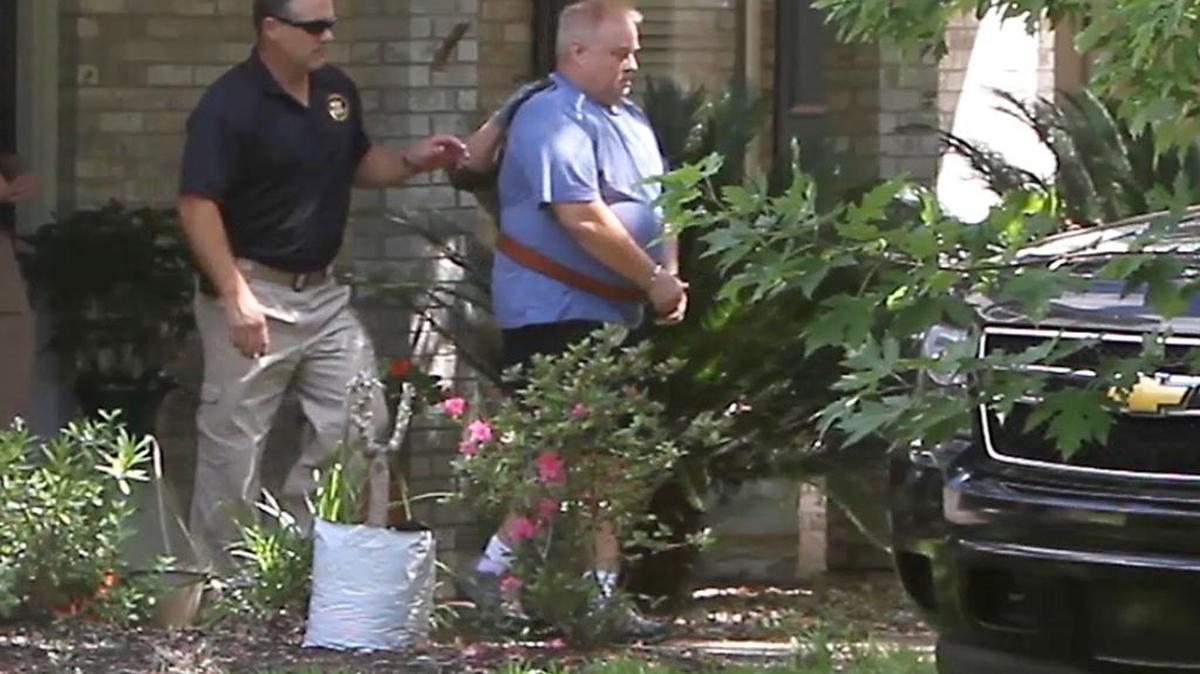 Philip Spear is led from a home in handcuffs on Temple Terrace in Ocean Springs on Thursday afternoon.