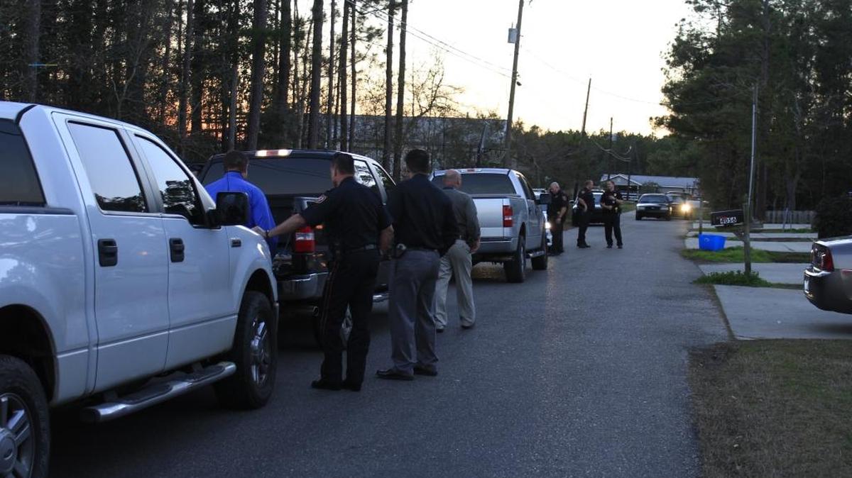 Waveland police gather near the scene of a shooting Thursday.