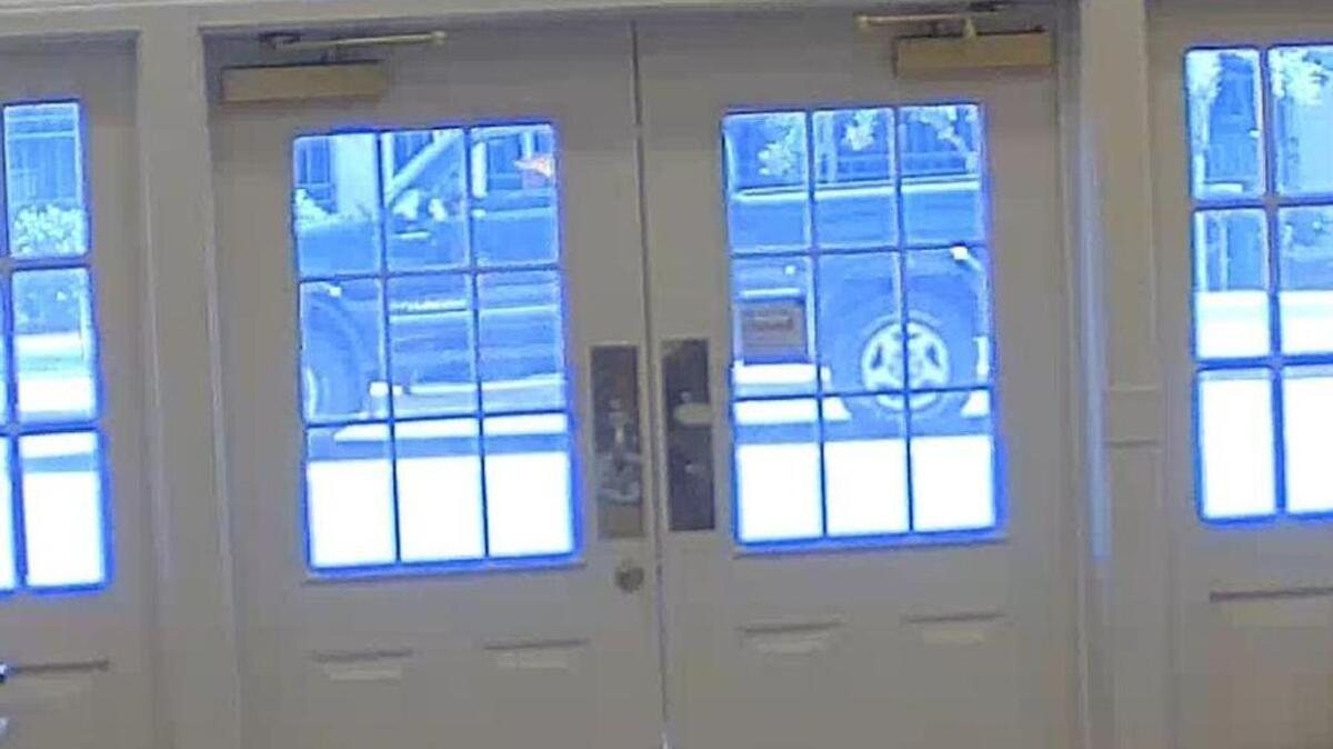 A Toyota Tundra sought in a hit-and-run in Biloxi is shown through the windows of Wells Fargo on Howard Avenue. Police are unsure if the driver, wearing a yellow hat, is a man or a woman.