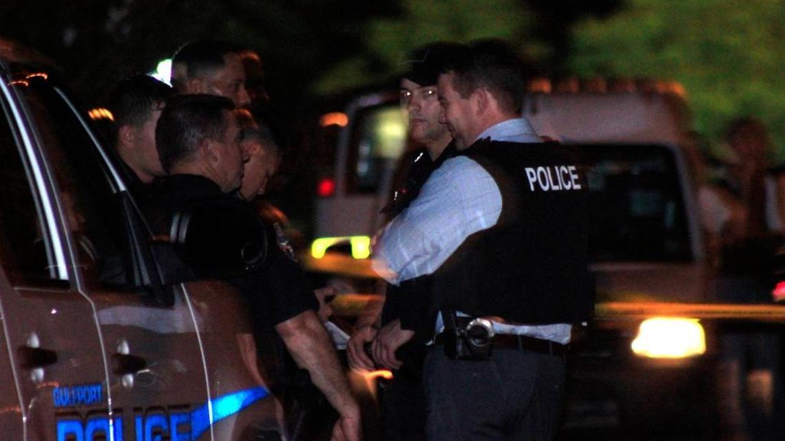 Gulfport police officers gather at the scene of a shooting on Monterey Drive on Tuesday night. A 20-year-old man was shot in the head in his grandmother's driveway.