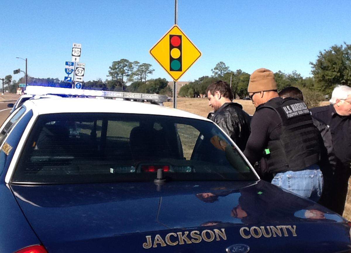 US Marshals put Michael “Pretty Boy Floyd” Wilson into a Jackson County patrol car in 2014 after Wilson was found hiding in woods in Ocean Springs after a police pursuit. Wilson was later convicted in 2015 of two murders in Harrison County and escaped from prison in Leakesville on July 5.