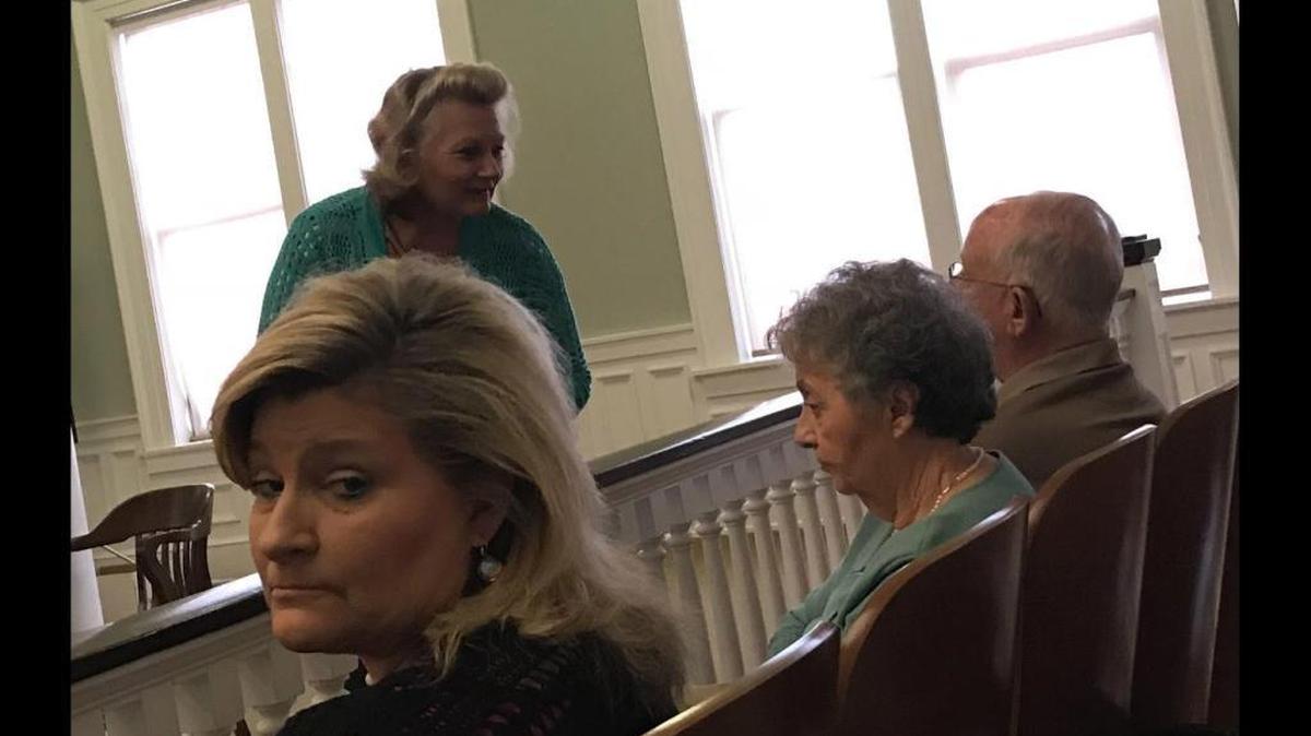 Carmon Brannon, center, smiles during her trial in George County on January 22, 2018. Brannon is accused of not giving a jail inmate the insulin he needed to treat diabetes.