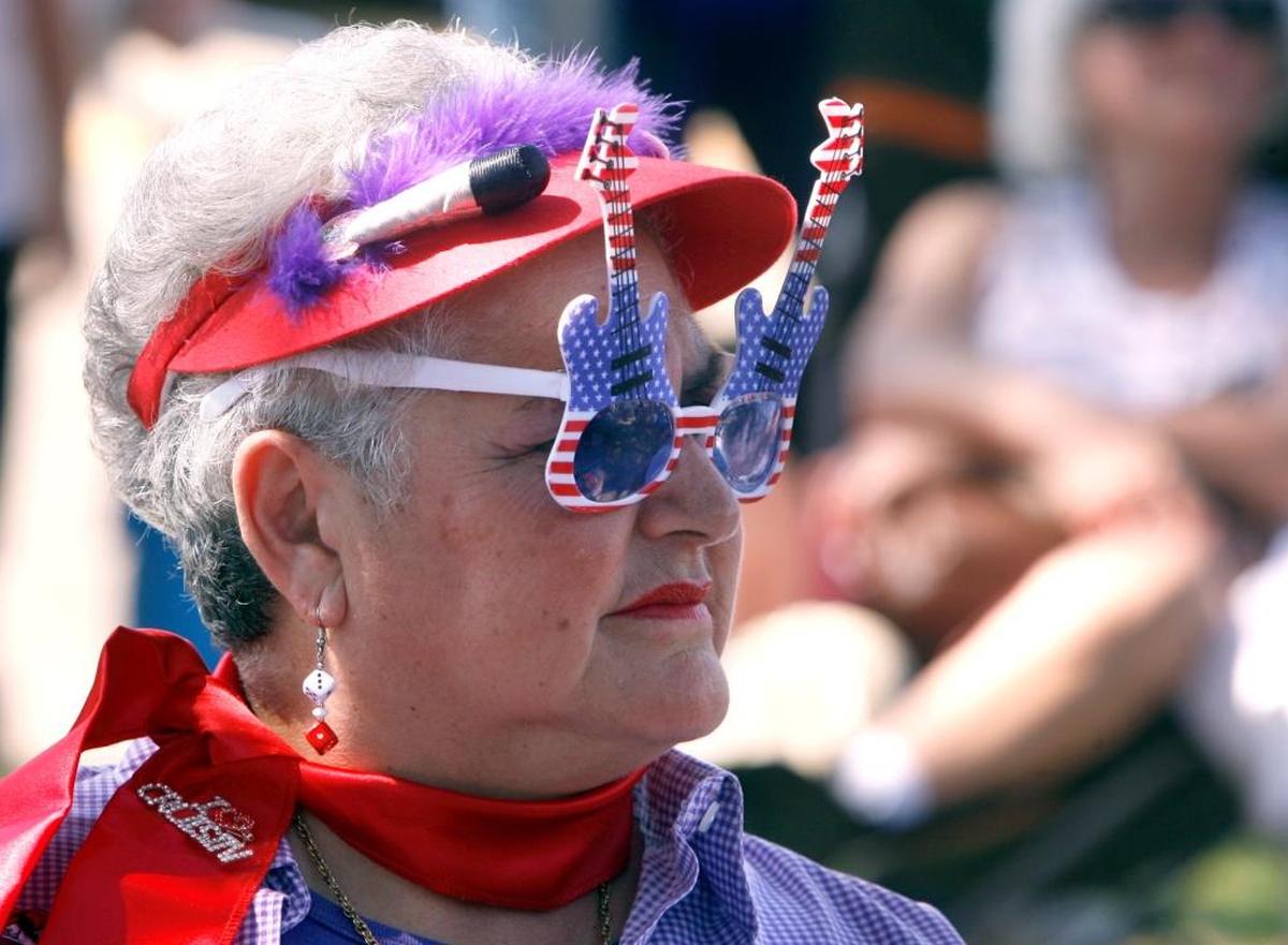 Darlene Stevens wears her guitar sunglasses as she listens to DD Thunders perform at the Town Green in Biloxi during a previous Cruisin' The Coast block party.
