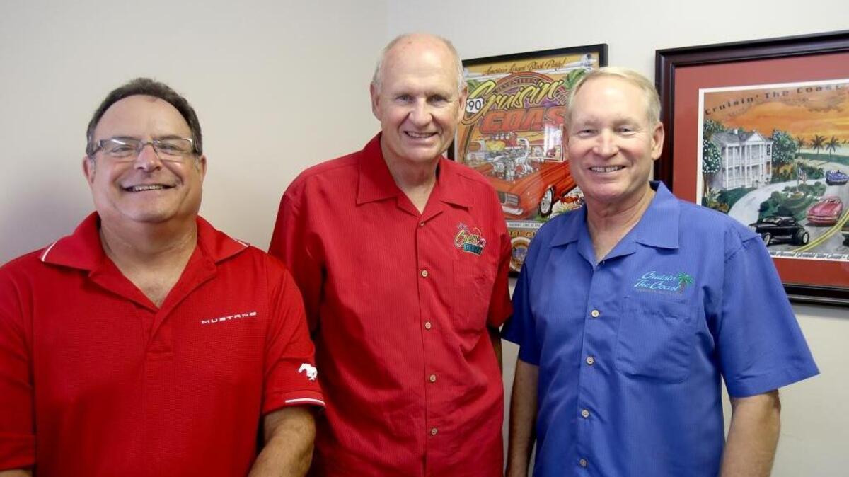 Crusin’ The Coast volunteers Craig Grisoli, left, and Terry Ward, center, stand with Cruisin’ The Coast executive director Woody Bailey on Monday, Sept. 19, 2016. Over 600 volunteers from 11 car clubs help keep Cruisin’ The Coast running smoothly.