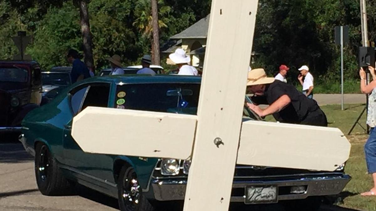 Rev. Paddy Mockler blesses a participant during the Blessing of The Classics in Diamondhead on Wednesday.