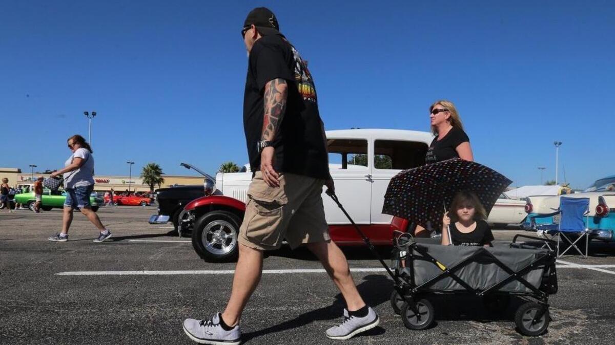 Steve Adams of Carriere pulls his daughter, Madison, 6, as he and his wife, Dustie, look at Cruisin' The Coast was at Edgewater Mall in Biloxi on Thursday, October 5, 2017. Adams came to the event in his 1969 Ford Falcon.