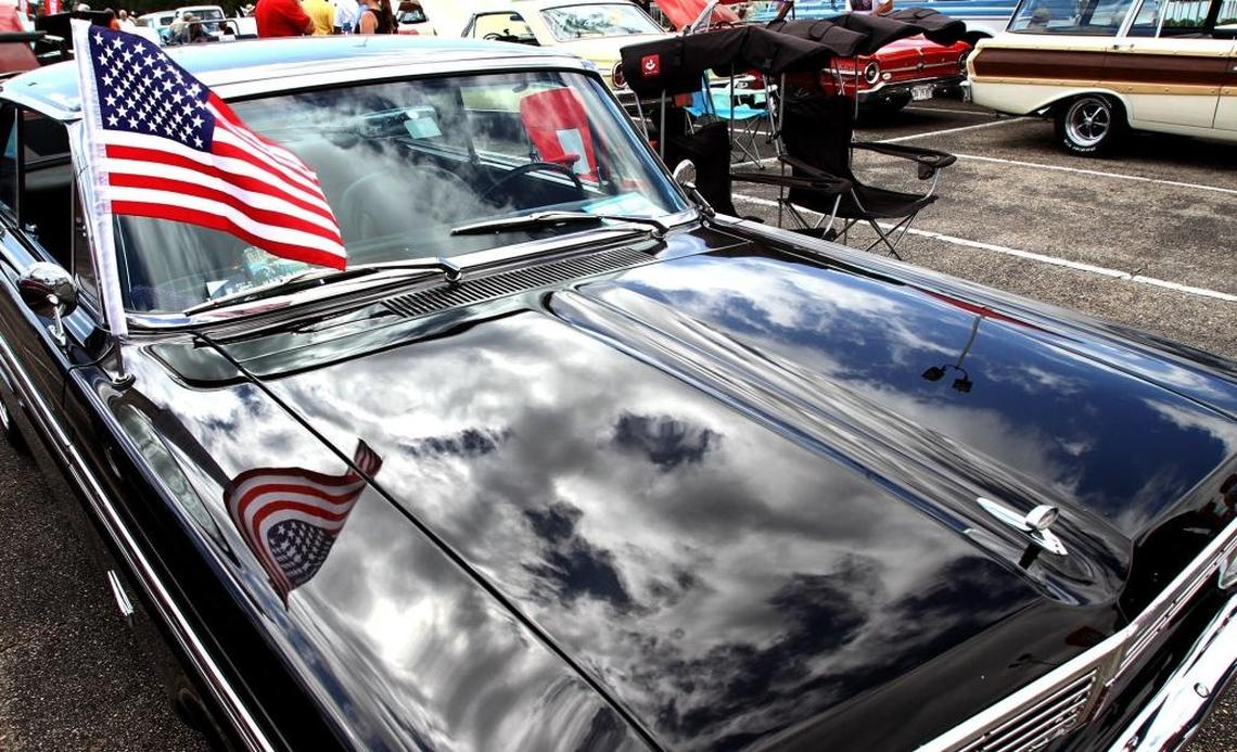 The U.S. flag and clouds are reflected in the hood of a 1965 Falcon in this Cruisin’ The Coast file photo taken in Biloxi. A Salute to Veterans is on Tuesday’s schedule at Cruise Central in Gulfport.