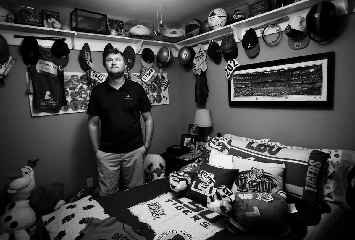 Tyler Schoenberger tears up as he looks around the room dedicated to his son’s memory. Jaxon Schoenberger died in 2014 after battling DIPG for eight months. He loved sports, especially baseball, and was given numerous signed balls and other mementos from local and professional teams during his illness. Photographer’s comments: Of all the interviews that I had while working on the paper’s DIPG project this year talking with Tyler and Salena Schoenberger impacted me the most. I learned a lot about holding grief and resilience from hearing their story. This was an unexpected moment that happened following the interview. I feel like the look on Tyler’s face — as he’s surrounded by all these things that symbolize the son he lost — says so much.