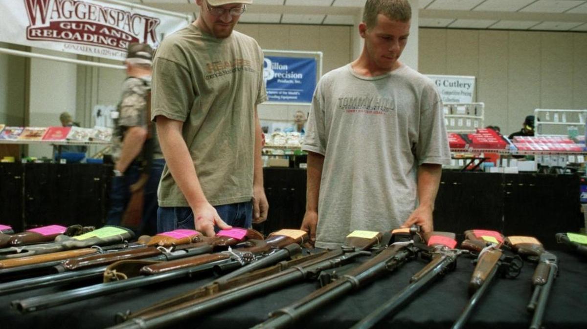 Jason Lindley, left, and Vincent Patricola, both of Gautier, look over collectible rifles and shotguns at exhibitor and collector Tom Larche’s booth at a previous U.S. Classic Gun Show at the Coast Convention Center. On Saturday and Sunday, the Biloxi Gun Show will be held again at the Coast Coliseum.