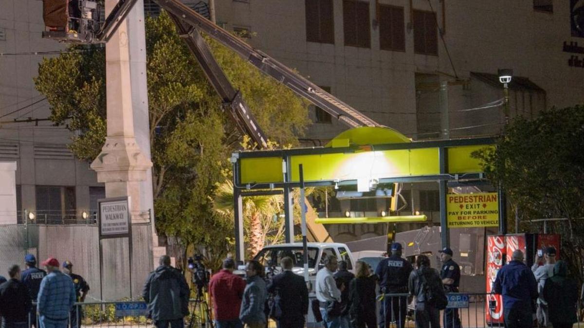A portion of a white supremacist monument is removed by the One Canal Place parking lot and Mississippi River floodwall at the end of Iberville Street in New Orleans, Louisiana on Monday.