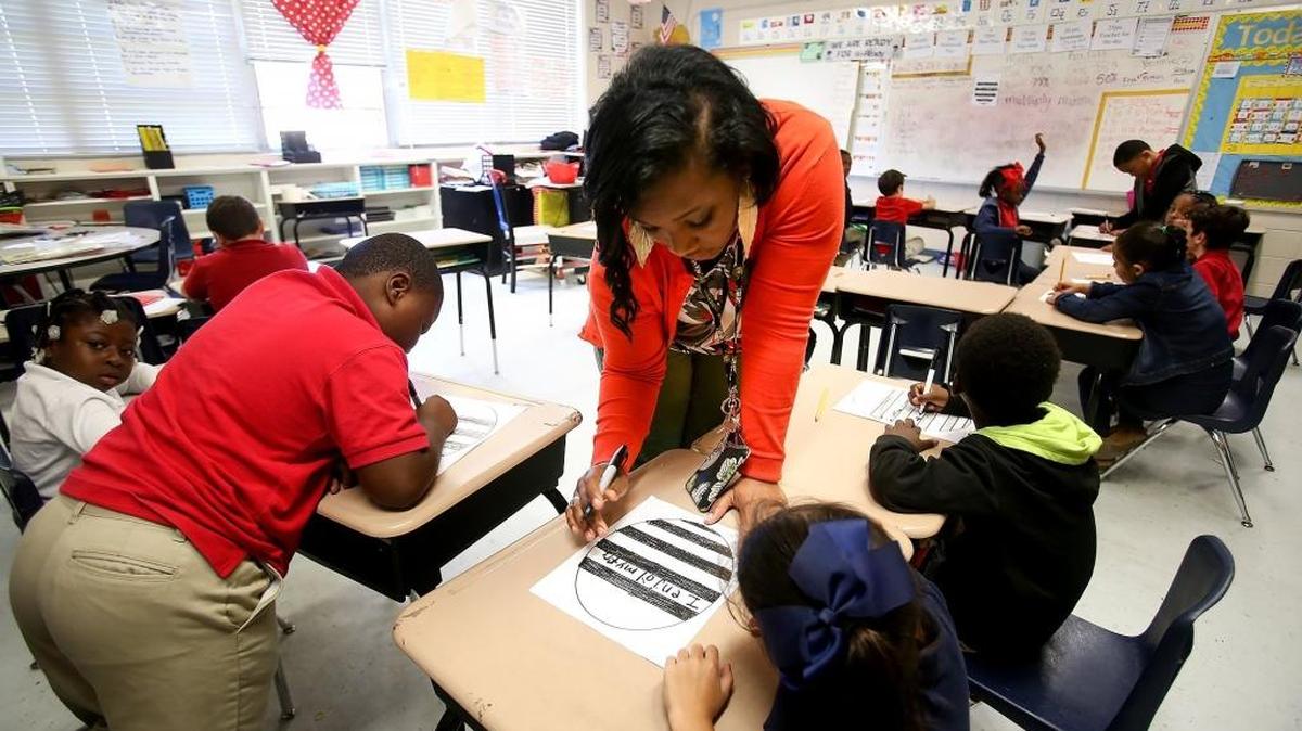 Arlington Elementary School teacher Nadis Chambers helps her second-graders April 25 in Pascagoula. President Donald Trump’s proposed education budget calls for the elimination of $2.3 billion Title II federal funding for the 2018-19 school year.