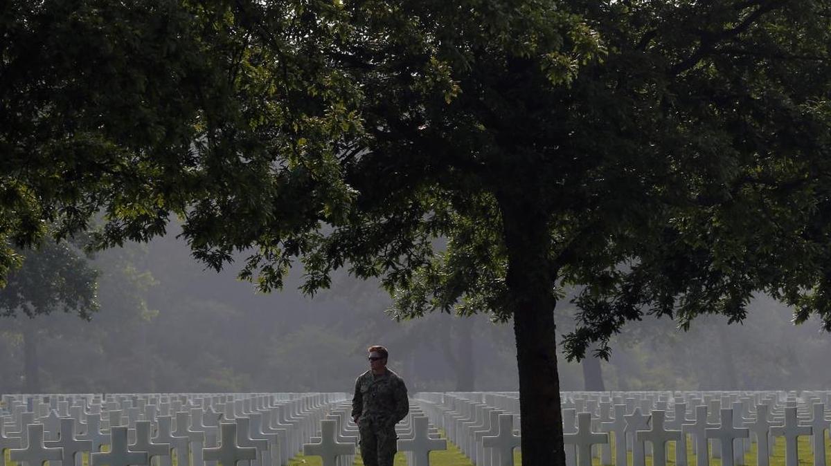 An American soldier, no name given, walks in the Colleville American military cemetery, in Colleville sur Mer, western France, Sunday June 5, 2015, on the eve of the 72nd anniversary of the D-Day landing. D-Day marked the start of a Europe invasion, as many thousands of Allied troops began landing on the beaches of Normandy in northern France in 1944 at the start of a major offensive against the Nazi German forces, an offensive which cost the lives of many thousands.