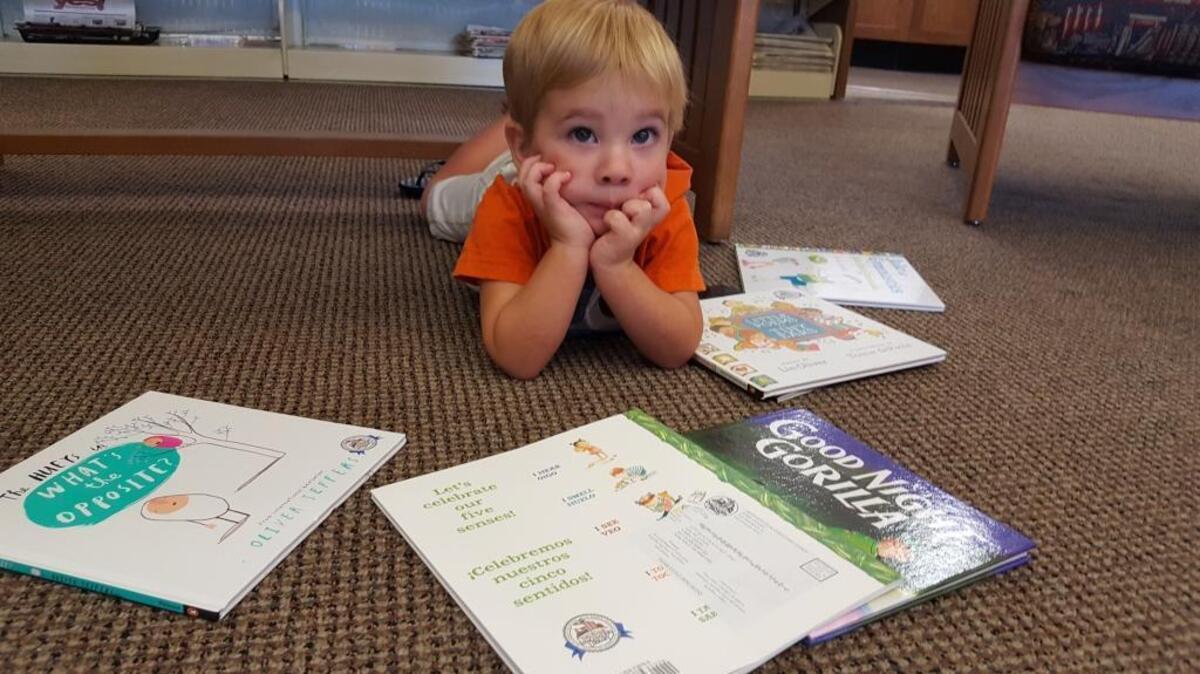 Walter Upton, 2, shows off his favorite books from Dolly Parton’s Imagination Library