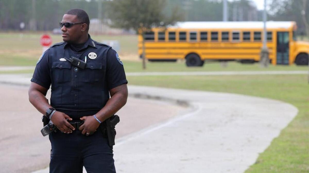 Harrison County Sheriff's deputy J. Britton stands outside West Harrison High School on Friday, Feb. 23, 2018. Britton is one of two officers assigned to the school on a daily basis.