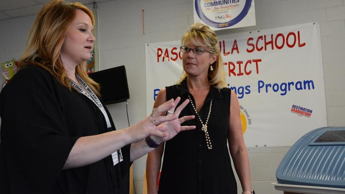 Director of early learning for the Pascagoula-Gautier School District Kelli McCorkle, from left, explains to Pascagoula State Farm Agent Brenda Simkins how the district will use a $25,000 grant that was awarded Nov. 30, 2016.