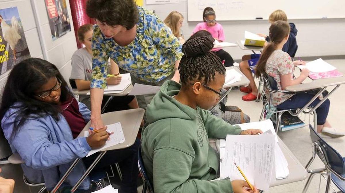 Angela Estrada helps Taylar Hanshaw in her Algebra I class at Gulfport High School on Thursday. Nov. 5, 2015.