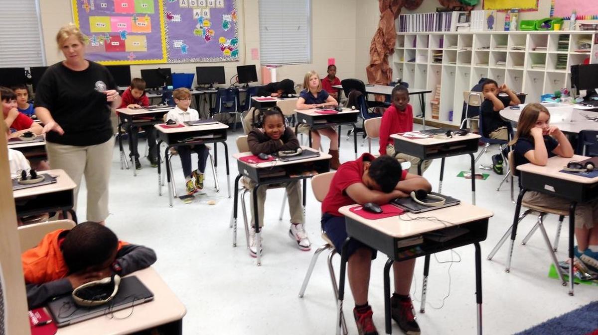 Third-grade students in Stephanie Slayter’s class at Cherokee Elementary School in Pascagoula in April 2015 wait for teachers to pick up computers after a computerized 50-question multiple choice reading test.