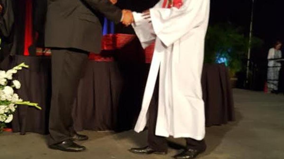 Amid a loud cheer, Cam'Ron Jackson accepts his Harrison Central High School diploma from school superintendent Roy Gill on Saturday, May 20, 2017.
