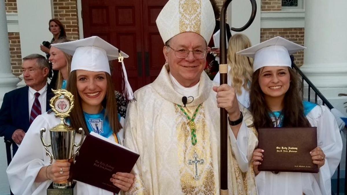 Valedictorian Abigail Koons, Bishop Louis Kihneman,III, and Salutatorian Sarah Sandoz