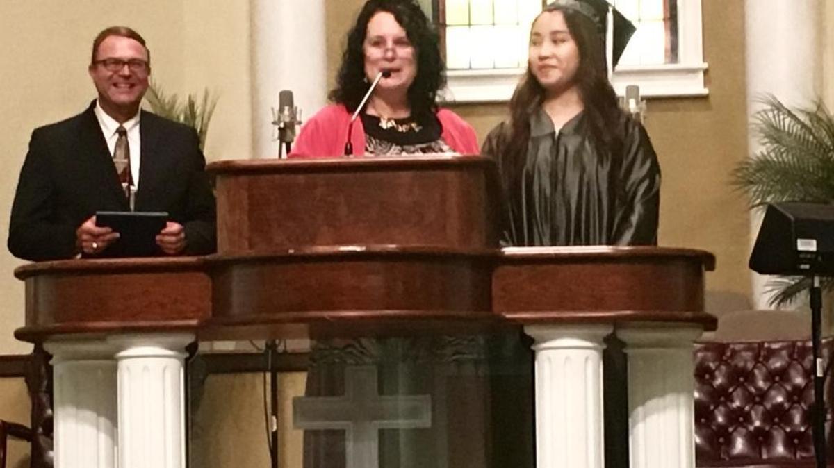Temple Christian Academy Class of 2017 valedictorian Anh Nguyen stands next to Principal Valerie Crane during the graduation ceremony on Sunday, May 28, 2017.